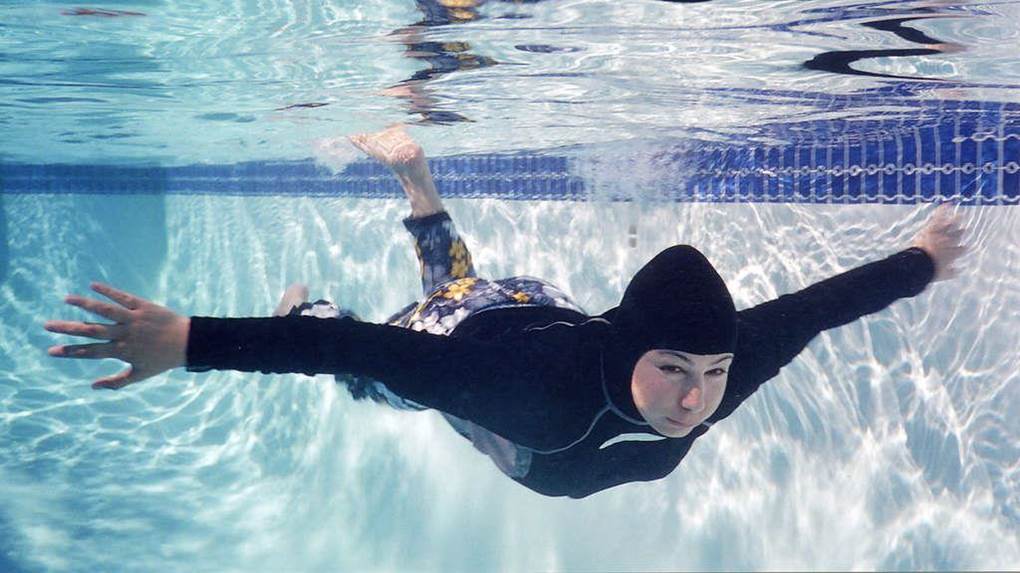Splashgear modest full-coverage swimsuit in the pool